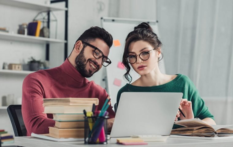 cheerful-man-in-glasses-sitting-near-female-collea-2022-02-06-04-53-29-utc.jpg