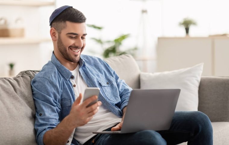 happy-jewish-man-using-mobile-phone-and-laptop-2021-07-07-03-37-17-utc.jpeg